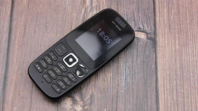 Push-button telephone black old. Outdated mobile phone. Button cell phone.