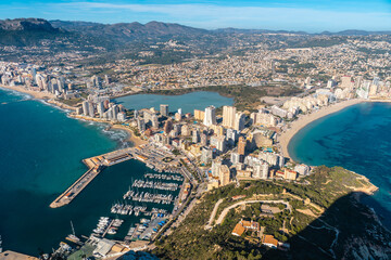 Obraz premium View of the city of Calpe from the top in the Penon de Ifach Natural Park, Valencia, Valencian Community. Spain. Mediterranean sea. View of the Cantal Roig and La Fossa beach