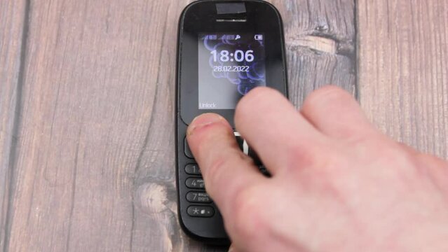 Push-button telephone black old. Outdated mobile phone. Button cell phone.