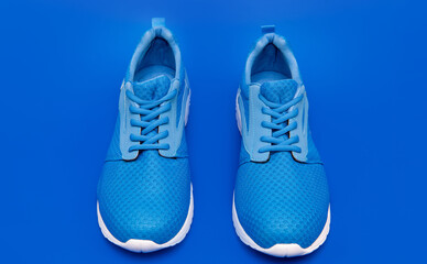 pair of footwear for training on blue background, sport fashion