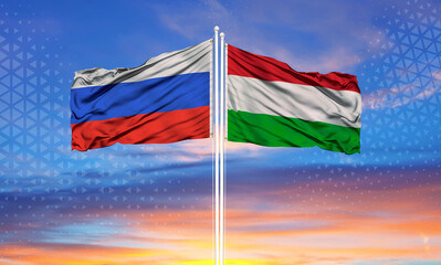 Hungary and Russia two flags on flagpoles and blue cloudy sky..