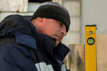 A portrait of an installer when working with a level