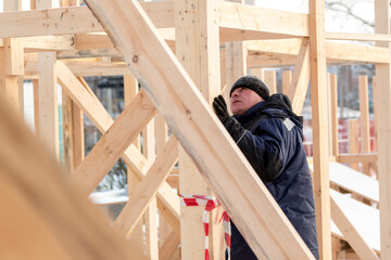 Worker assembling the frame of a wooden slide