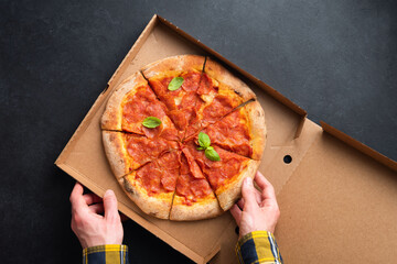 Delicious Pepperoni Pizza In Carton Cardboard. Male Hands Picking Slice Of Hot Pepperoni Pizza,...