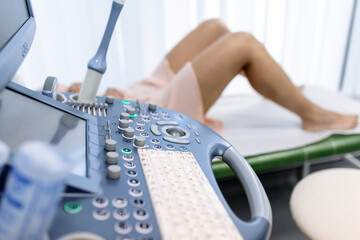 Happy pregnant female visiting women's doctor in the maternity center, doing ultrasound scan, worried about the health of the child, healthy motherhood concept