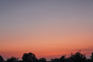Fototapeta na wymiar orange-pink sky at dawn, colorful sky, dawn sky background, copy space