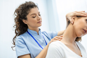 Physiotherapist doing healing treatment on womans neck,Chiropractic adjustment, pain relief...