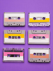 Collection of cassette tapes on purple background.