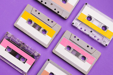 Collection of cassette tapes on purple background.