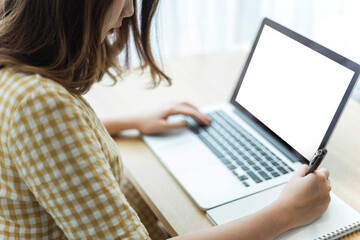 Entrepreneur concept a young female entrepreneur doing notetaking on her notebooks to create meeting agenda
