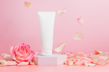Unbranded tube of face cream with rose and petals, natural skin care mockup, bottle for branding of lotion, cream or gel