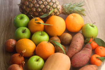Various healthy fruit and vegetable on wooden background. Selective focus.