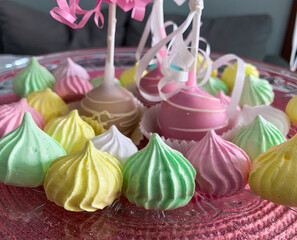 Close up meringues kisses in vivid colors: yellow, green, pink, blue and white.  