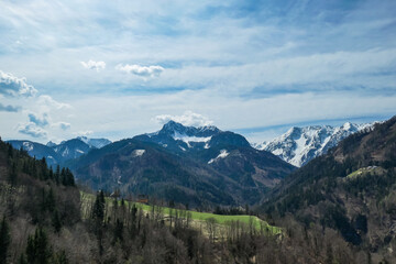 Scenic view of snow capped mountain peaks of Karawanks near Sinacher Gupf in Carinthia, Austria. Mount Wertatscha and Hochstuhl (Stol) is visible in early spring. Hills in Rosental on sunny day. Hike