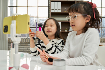 Elementary school children playing Beauty YouTuber