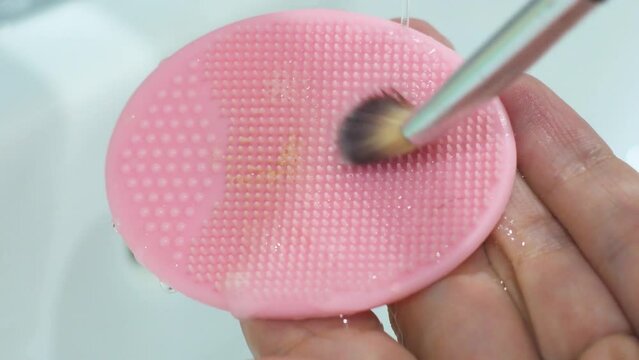 Cleaning The Brush After Makeup On A Silicone Sponge