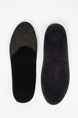 Black Insoles isolated on a white background. Medical orthopedic insoles. Foot care. Insole cutaway...