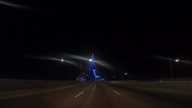 Driving over the Gerald Desmond Bridge in Long Beach California at nighttime - driver point of view