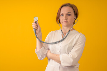 The doctor has prepared a stethoscope for work. On a yellow background.