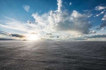 Empty asphalt road platform and beautiful blue sky with white clouds at sunrise - obrazy, fototapety, plakaty