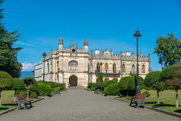 Fototapeta premium Beautiful historical and architectural museum of Dadiani palaces, located in a park in Zugdidi on a sunny bright day, Georgia