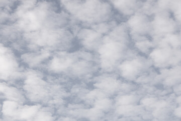 white fluffy clouds in the blue sky .blue sky background with tiny clouds