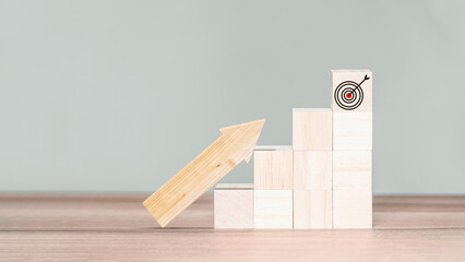 Wooden cube block with percentage sign and wood arrow up, Business growth and goal in next year concept.