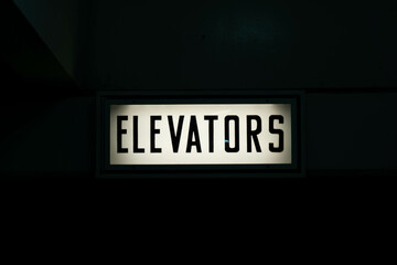 Elevators Sign in a dark corner.