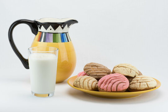 A Glass Of Milk, Colorful Pitcher And Mexican Concha Bread