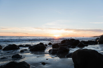 Rock Silhouettes on the beach at sunset