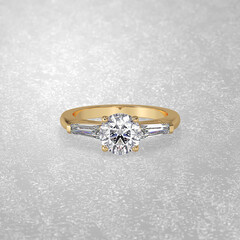 3 stone engagement ring laying down position in yellow gold 3D render