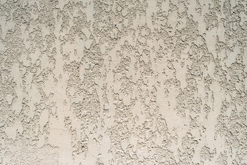 Close-up, the texture of the facade of decorative beige plaster.