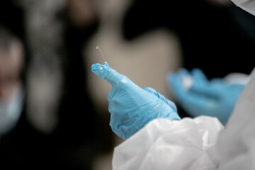 Doctor, nurse, scientist, researcher hand in blue gloves holding flu, measles, coronavirus,...