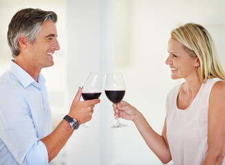 They both love romance and red wine. Shot of an affectionate couple toasting with red wine.