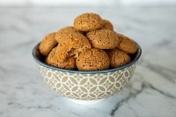 Amaretti cookies in bowl. Small soft Italian traditional sweet-bitter pastry dessert.