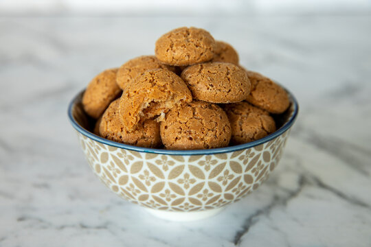 Amaretti cookies in bowl. Small soft Italian traditional sweet-bitter pastry dessert.