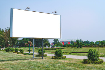 Blank billboard mockup with white screen. Against the backdrop of nature and blue sky. Business concept. Copy space banner for advertising.