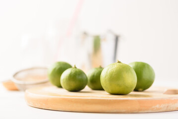 Fresh lime fruit from local market on white background is prepared as an ingredient in refreshing summer drinks.