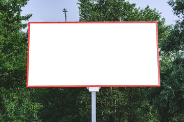 Blank billboard mockup with white screen. Against the backdrop of nature and blue sky. Business concept. Copy space banner for advertising.