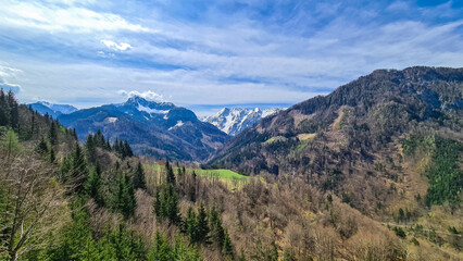 Scenic view of snow capped mountain peaks of Karawanks near Sinacher Gupf in Carinthia, Austria. Mount Wertatscha and Hochstuhl (Stol) is visible in early spring. Hills in Rosental on sunny day. Hike
