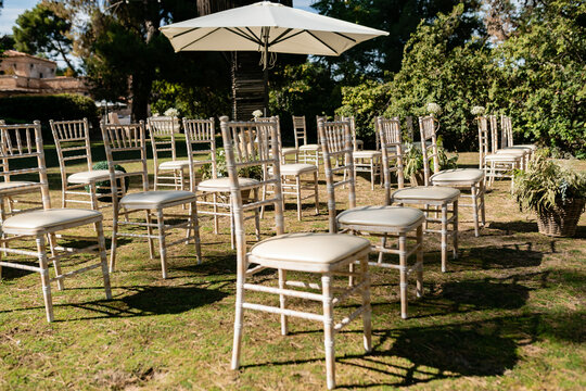 Rows of chairs for wedding ceremony in backyard