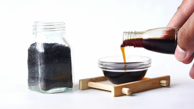 Black Cumin oils and seeds on white background 