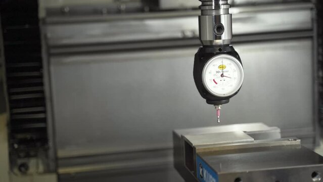 3D Taster dial indicator on a CNC machine lowered onto a steel bar.