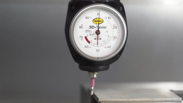 3D Taster dial indicator measuring, zeroing out dimensions, close up.