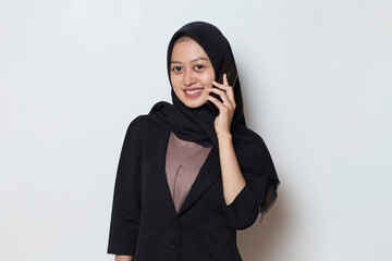 happy young asian muslim business woman using mobile phone
