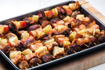 skewers with poultry meat, bacon and onion
