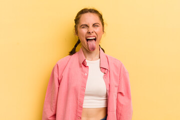 young pretty woman with cheerful, carefree, rebellious attitude, joking and sticking tongue out,...