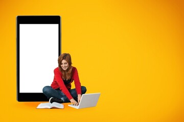 Big phone behind woman. Girl is sitting with laptop. Big blank screen smartphone.