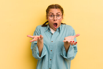 young pretty woman feeling extremely shocked and surprised, anxious and panicking, with a stressed...