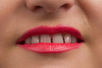 Fototapeta premium toothy smile of human red lips closeup